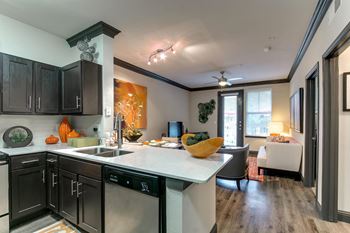 a kitchen with an island and a living room with a couch